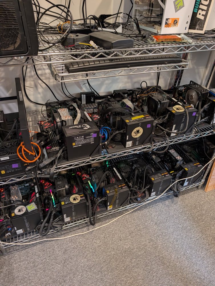 The Studio 45 rack: chrome wire shelving with open-frame test benches on two shelves, EVGA power supplies and tower CPU coolers